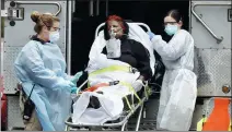  ?? STEFAN JEREMIAH / REUTERS ?? Emergency medical technician­s wheel a patient to an ambulance during the outbreak of COVID-19 in New York on Saturday.