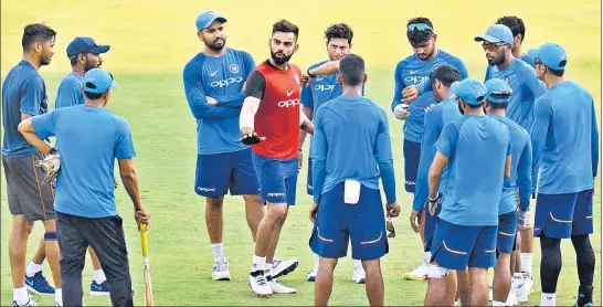  ?? AFP ?? India captain Virat Kohli interacts with teammates during a training session in Chennai ahead of the first ODI against Australia on Sunday.
