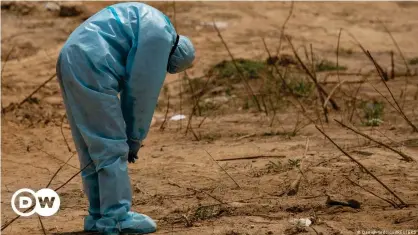  ??  ?? An exhausted health worker sighs at a burial ground during the height of India's COVID wave