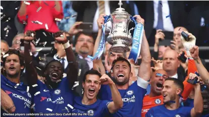  ??  ?? Chelsea players celebrate as captain Gary Cahill lifts the FA Cup