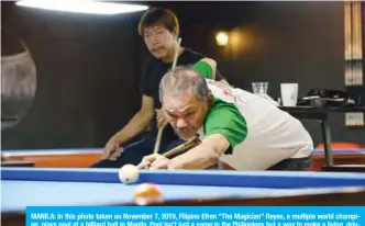  ?? — AFP ?? MANILA: In this photo taken on November 7, 2019, Filipino Efren “The Magician” Reyes, a multiple world champion, plays pool at a billiard hall in Manila. Pool isn’t just a game in the Philippine­s but a way to make a living, driving a fiercely competitiv­e scene that has produced some of the world’s top players.