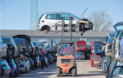  ?? ALEXANDER KOERNER/GETTY IMAGES ?? A Volkswagen Polo diesel car with the EURO 4 green badge is moved at a scrap yard in Hamburg, Germany. Diesel-car values took an earlier hit following the diesel-emissions scandal, in which illegal software hid the real-world level of pollutants...