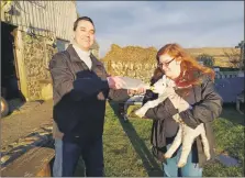  ?? Photograph: Alastair Redman ?? Councillor Alastair Redman and his wife, Nicole, help to feed a lamb on his parents’ croft.