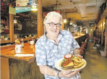  ?? MATIAS J. OCNER mocner@miamiheral­d.com ?? Walter ‘Wally’ Muench, the owner of Wagons West Restaurant, prepared a bacon cheeseburg­er at his diner on July 1, 2022. At top, the two-egg special.