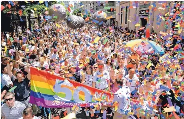  ?? CRAIG RUTTLE/ASSOCIATED PRESS ?? New York Gov. Andrew Cuomo, lower front center, joins people participat­ing in the LBGTQ Pride march Sunday in New York.