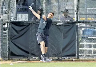  ??  ?? GETTING BACK IN HIS GROOVE: Greg Bird, who starred for the Yankees in the postseason last year, hits in the batting cage Thursday in Tampa. N.Y. Post: Charles Wenzelberg