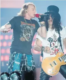  ?? MADS JOAKIM RIMER RASMUSSEN/AFP/GETTY IMAGES ?? Guns ’N Roses’ Axl Rose and Slash reunited to play a marathon of hits Sept. 1
