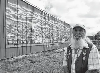 ?? CAPE BRETON POST FILE PHOTO ?? Artist Keith Baldwin is shown with one of his murals in Whitney Pier. Baldwin, 61, died on Monday.
