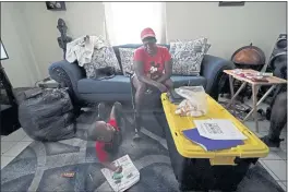  ?? GERALD HERBERT — THE ASSOCIATED PRESS ?? Natasha Blunt sits in her apartment in Chalmette, La., on Monday with her grandson Kamille Blunt, 5, in the aftermath of Hurricane Ida.