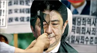  ??  ?? A protester chops an effigy of Japanese Prime Minister Shinzo Abe with an axe during an antiJapan rally on the occasion of the 70th anniversar­y of liberation from Japan's 1910-45 colonial rule, on Liberation Day in Seoul, South Korea. REUTERS