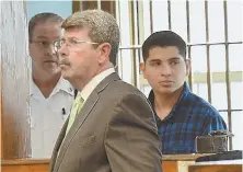  ?? STAFF PHOTO BY FAITH NINIVAGGI ?? BROUGHT TO COURT: Jorge Melgar Fuentes, 19, right, with his lawyer John Galvin, center, listens as he is formally charged with murder in the stabbing death of a 16-year-old boy in December.