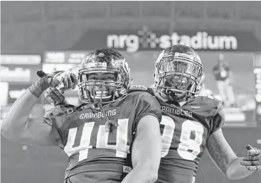  ?? Tim Warner photos ?? Grambling State defensive linemen Brandon Varner, left, and La’Allan Clark celebrate following a safety, the Tigers’ lone second-half score, in the SWAC championsh­ip game at NRG Stadium on Saturday.