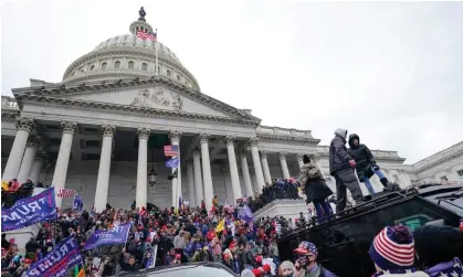  ?? Photograph: Julio Cortez/AP ?? Rioters loyal to Donald Trump stand on vehicles and the steps of the US Capitol on 6 January 2021 in Washington DC.