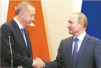  ?? AP-Yonhap ?? Turkish President Recep Tayyip Erdogan and Russian President Vladimir Putin shake hands during a joint press conference following their talks in the Bocharov Ruchei residence in the Black Sea resort of Sochi, Russia, Tuesday.