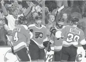  ?? BRUCE BENNETT/GETTY IMAGES ?? Flyers left winger Michael Raffl, center, celebrates second period goal against the Rangers.