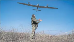 ?? REUTERS ?? A Ukrainian serviceman launches a reconnaiss­ance drone towards Russian positions near Bakhmut on Tuesday.