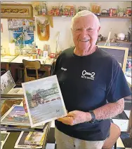  ?? Westside Eagle Observer/DANIEL BEREZNICKI ?? Cecil Savage displays a print of one of his original War Eagle Mill paintings.