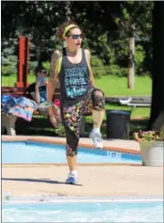  ??  ?? Sherri Freifelder, a licensed aqua Zumba instructor, demonstrat­es dance fitness moves as she teaches a class at the North End Swimming Club outdoor pool in Pottstown.