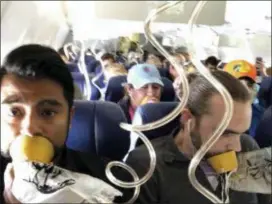  ?? MARTY MARTINEZ VIA AP ?? In this April 17, 2018 photo provided by Marty Martinez, Martinez, left, appears with other passengers after a jet engine blew out on the Southwest Airlines Boeing 737 plane.