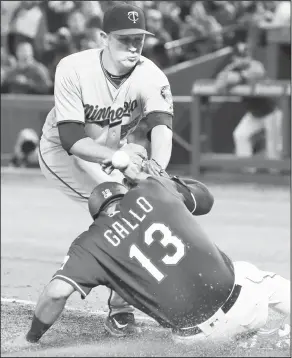  ?? Associated Press ?? Safe: Minnesota Twins relief pitcher Tyler Duffey can't handle the ball allowing Texas' Joey Gallo (13) to score on a wild pitch during the sixth inning of a baseball game on Wednesday in Arlington,Texas.