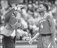  ?? AP/AL.com/VASHA HUNT ?? Arkansas coach Mike Anderson gives instructio­ns to his team Saturday while guard Daryl Macon walks to the bench during the Razorbacks’ 76-73 victory over the Crimson Tide on Saturday in Tuscaloosa, Ala. Macon led the Hogs with 17 points.