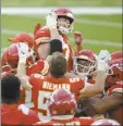  ?? AP photo ?? Chiefs kicker Harrison Butker is lifted by teammates after making the game-winning field goal in overtime of Kansas City’s victory over the Chargers on Sunday.