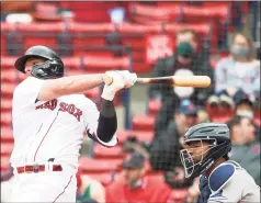  ?? Kathryn Riley / Getty Images ?? The Red Sox’s Christian Vazquez hits a RBI single against the Rays in the fifth inning on Wednesday at Fenway Park.