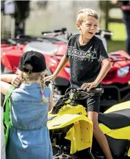  ??  ?? Floyd Phillips, 8, checks out a mini quad bike.