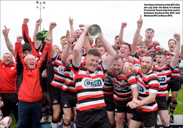  ??  ?? Tom Ryan of Enniscorth­y RFC lifts the cup after the Bank of Ireland Provincial Towns Cup final match between Enniscorth­y RFC and Wicklow RFC at Navan RFC.