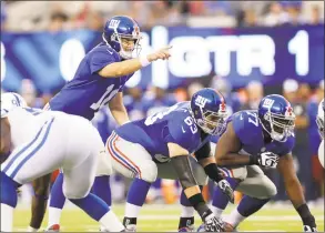  ?? Kathy Willens / Associated Press ?? Eli Manning and the Giants are counting on their revamped offensive line to help pave the way for the team this season.