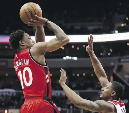  ?? GETTY IMAGES ?? The Raptors’ DeMar DeRozan shoots over Bradley Beal of the Wizards during the first half of Toronto’s 114-106 win over Washington on Friday night. DeRozan drained 32 points in a crucial win for the Raptors.