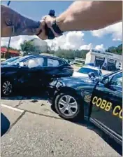  ?? COURTESY ?? Video released this week shows a Cobb County officer firing a dozen rounds at 28-year-old Devonte Brown following a 2021 police chase in Marietta. A grand jury declined to indict the officer.