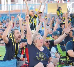  ??  ?? Andrea Oyler, center, celebrates with other fans during a watch party at Civic Plaza for the New Mexico United’s game in the U.S. Open Cup.