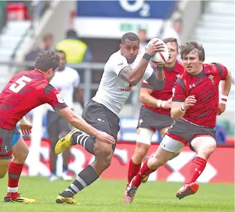  ?? Photo: Ian Muir ?? Vodafone Fijian 7s rep Samisoni Viriviri on the attack against Wales during the London 7s pool games yesterday.