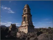  ?? (AP/Eduardo Verdugo) ?? A church tower on Feb. 21 peeks above from where lava from the Paricutin volcano buried the church decades ago.