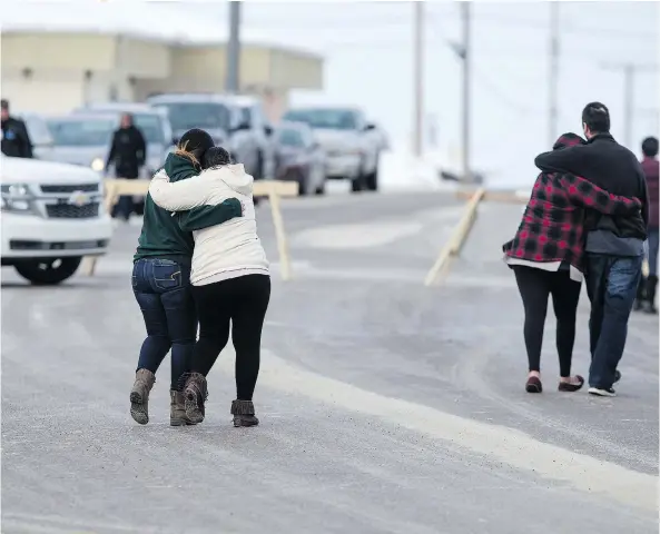  ?? LIAM RICHARDS ?? Community members walk past RCMP barricades outside the La Loche courthouse on Friday. Security was tight, with those allowed into the small courtroom having to pass through airport-like checks while the convicted gunman appeared in a bulletproo­f vest.