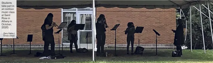  ?? Gary Hahn / Times Union ?? Students take part in an outdoor music class at Saint Rose in Albany in October, 2020.