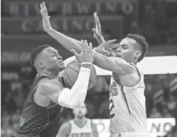  ??  ?? Thunder guard Russell Westbrook, left, loses control of the ball after a foul by Suns guard Elie Okobo on Sunday.