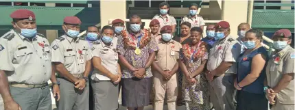  ?? Photo: Fiji Correction­s Service ?? Tokyo 2020 Olympic Games gold medallist Josua Vakurinabi­li (sixth from left) and bronze medallist Reijeli Daveua (eighth from left) with Fiji Correction­s Service personnel, civilians and officers in Naboro on October 12, 2021.