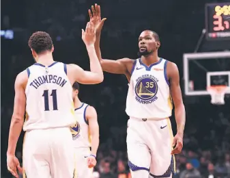  ?? Matteo Marchi / Getty Images ?? Shooting guard Klay Thompson, who scored 18 points, and forward Kevin Durant, who had 34, helped lead the Warriors to a sixth win in seven games.