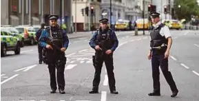  ?? REUTERS PIC ?? Police officers standing guard outside the Natural History Museum after a car mounted the pavement, injuring pedestrian­s in London yesterday.