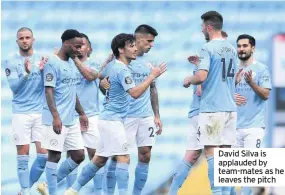  ??  ?? David Silva is applauded by team-mates as he leaves the pitch