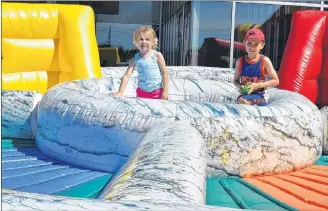  ?? DESIREE ANSTEY/JOURNAL PIONEER ?? Mariah and Denzel Hackett play on the bouncy castle outside the Credit Union Place on Saturday morning as the Young Leaders Program Tradeshow and Expo took place inside.