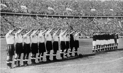  ??  ?? The England football team give the Nazi salute before kick-off against Germany in Berlin, 14 May 1938