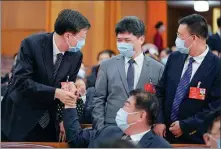  ?? FENG YONGBIN / CHINA DAILY ?? National People’s Congress deputies greet each other at a preparator­y meeting for the third session of the 13th NPC.