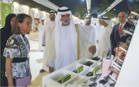  ?? Khushnum Bhandari for The National ?? Sheikh Nahyan bin Mubarak, Minister of State for Tolerance, visits artisan stallholde­rs at Ataya. Among the attraction­s this year is Nashwa Jewellery, above left, with its emphasis on sustainabl­e sourcing of pearls