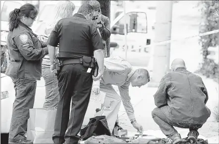  ?? MIKE NELSON/EPA ?? Law enforcemen­t officers inspect possible evidence from a car in Santa Monica, Calif., after a man was arrested early Sunday. Assault rifles and chemicals used in explosives were found in the vehicle and the man said he wanted to cause harm at a gay...