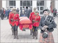  ?? CP PHOTO ?? A piper leads the casket outside a memorial service Saturday for former federal Liberal cabinet heavyweigh­t Allan J. MacEachern in Antigonish, N.S.