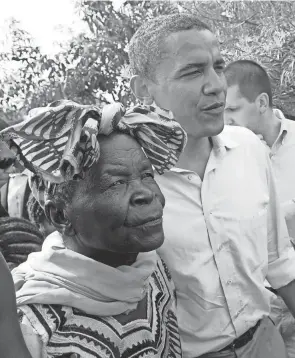  ?? SAYYID AZIM/AP FILE ?? Then-u.s. Sen. Barack Obama walks with his grandmothe­r Sarah Obama at his father’s house in Kogelo village, western Kenya, in 2006.