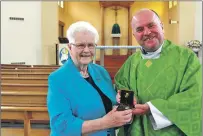 ?? Photograph by Anthony MacMillan Photograph­y. ?? Sister June receives her gift from Father Roddy McAuley from the parish of St John’s, Caol.